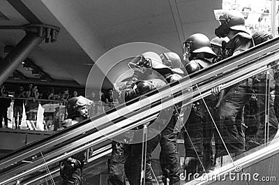 German police special forces in a stand by on an escalator in black and white Editorial Stock Photo